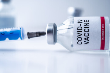 A single bottle vial of Covid-19 vaccine. Medical concept vaccination hypodermic injection...