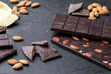 
Handmade raw vegan chocolate with almonds on dark graphite background