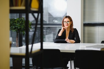 beautiful young woman on the workplace using a digital tablet