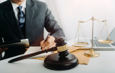 justice and law concept.Male judge in a courtroom on wooden table and Counselor or Male lawyer...