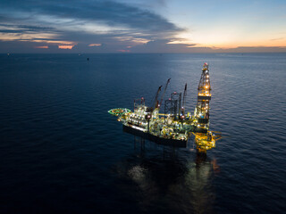 Aerial view offshore drilling rig (jack up rig) at the offshore location during sunset