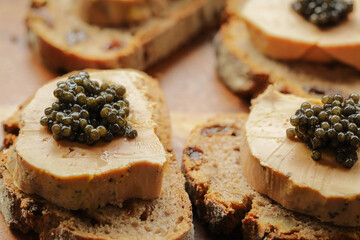 Sturgeon black caviar on foie gras and cutting bread, fevtive celebreation concept - obrazy, fototapety, plakaty