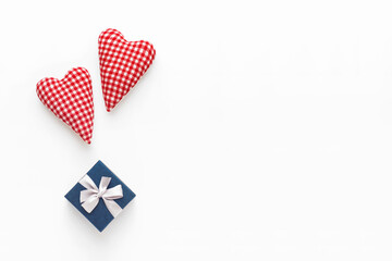 Valentines day composition. Two soft red hearts and gift box on white background. Flat lay, top view, copy space