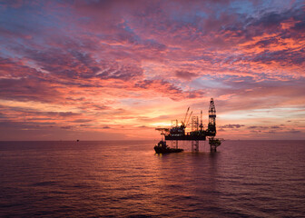 Fototapeta na wymiar Aerial view offshore drilling rig (jack up rig) at the offshore location during sunset