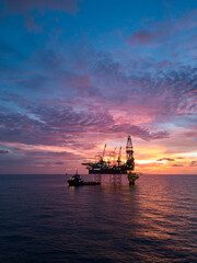 Aerial view offshore drilling rig (jack up rig) at the offshore location during sunset