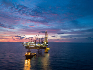 Aerial view offshore drilling rig (jack up rig) at the offshore location during sunset