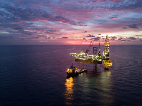 Aerial view offshore drilling rig (jack up rig) at the offshore location during sunset