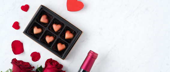 Top view of Valentine day chocolate with rose and wine, festive gift design concept