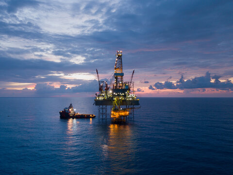 Aerial view offshore drilling rig (jack up rig) at the offshore location during sunset