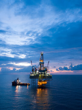 Aerial view offshore drilling rig (jack up rig) at the offshore location during sunset