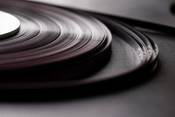 A vintage audio tape reel on black background