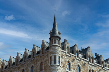 Battlement fortress wall with the round tower against the sky