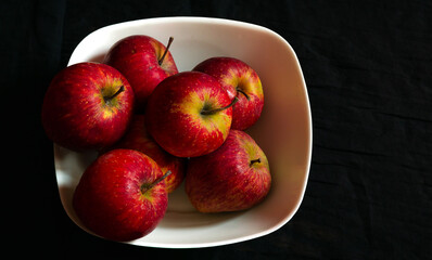 A bunch of healthy apples stacked together in a bowl