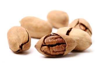 Peeled pecan nuts closeup, isolated on white background