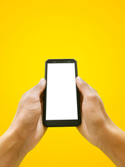 Man holding smartphone with blank screen on Yellow background, closeup of hand. Space for text