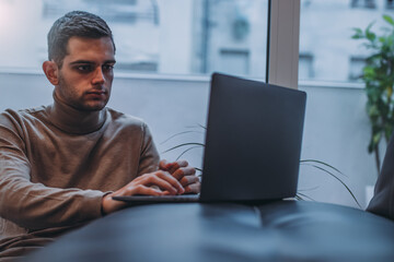 man working at home with laptop