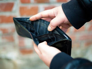Bankrupt man with no money in his wallet and an unfinished house