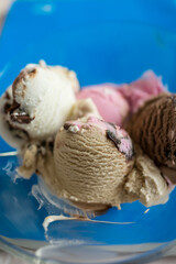 Ice cream scoops on wooden table, close-up