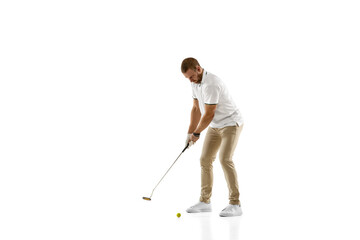 Passioned. Golf player in a white shirt taking a swing isolated on white studio background with copyspace. Professional player practicing with bright emotions and facial expression. Sport concept.