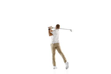 Achievement. Golf player in a white shirt taking a swing isolated on white studio background with...