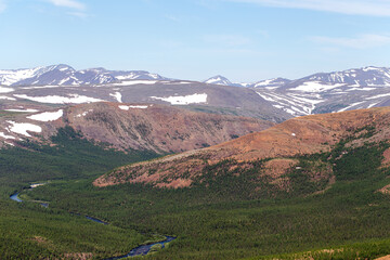 Fototapeta na wymiar Glacier mountain peaks. Northern landscape. View from helicopter flight altitude