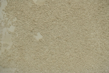Textured background of an old wall made of beige plaster. Smooth surface. Cracks. Copy space. © Yuliya