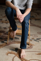 Teen boy assembles furniture according to the instructions - a wooden chair. Housework and order in...