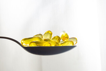 Cod Liver Oil Capsules on spoon omega 3
