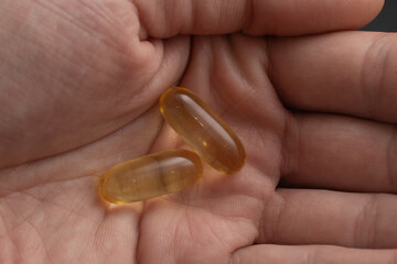 Holds Vitamin D Supplements omega 3 healthy diet concept