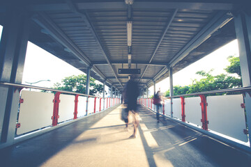 People walking on the skywalk. blurred business people  walking at walkway