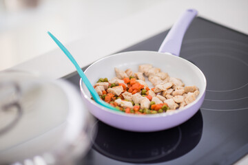 Preparing food in modern white kitchen