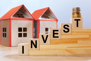 House models and inscription on wooden cubes - Invest