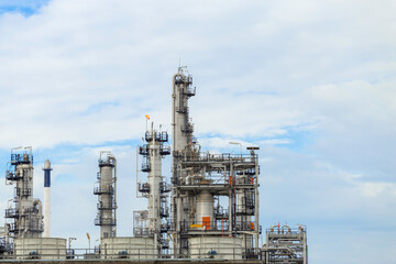 Industrial of oil refinery plant from industry zone ,Refinery factory oil storage tank and pipeline steel with blue sky.