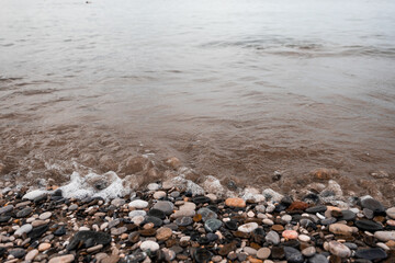 summer
pebble beach and raging sea
focus on stones