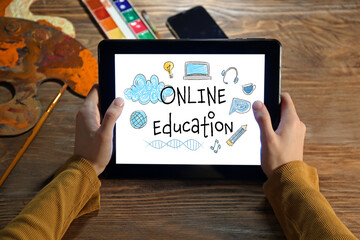 Young woman using tablet computer for online learning at home