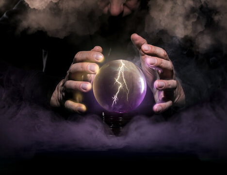 Fortune teller with crystal ball on dark background, closeup