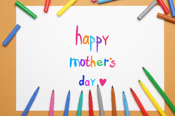 Text HAPPY MOTHER'S DAY on paper sheet with felt-tip pens on color background