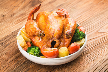 roasted chicken and vegetables on wooden table