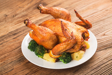 roasted chicken and vegetables on wooden table