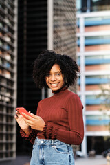 Fototapeta premium Businesswoman using her mobile phone outdoors.