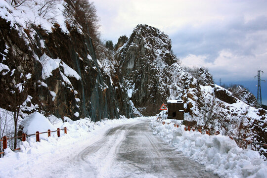 snowy mountain road in the white apuan alps on a winter day