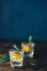 Charred Lemon, Rosemary and Coriander Gin and Tonic is a flavors are perfectly balanced refreshing cocktail. on dark background, close up