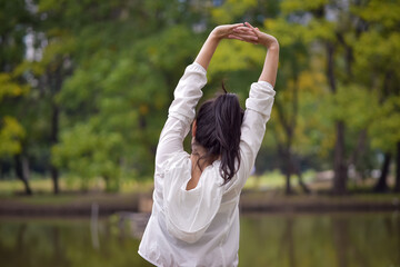 Asian woman is warm up, To make the muscles flexible Before going to jogging for good health and energy metabolism,Outdoors cross training workout. Healthcare concept