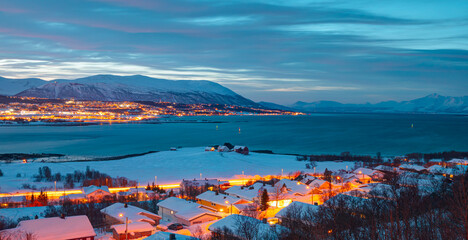 Beautiful winter or urban landscape of Tromso in Northern Norway at twilight blue hour - Arctic city of Tromso with bridge -Tromso, Norway