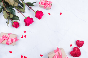 Rose flowers with presents on table from above with copy space, flat lay