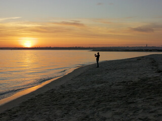 Sunset at beach with photographer