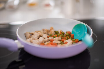 Making salad for lunch in modern kitchen