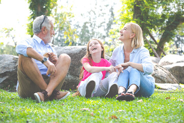 Happy Old Grandparents Having Fun With Grandchildren In Park