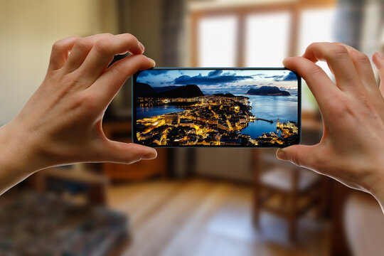 Norway city Aalesund on the screen. View famous tourist spots from home via smartphone.