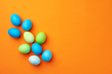 Fototapeta na wymiar Painted Easter eggs on orange background top view